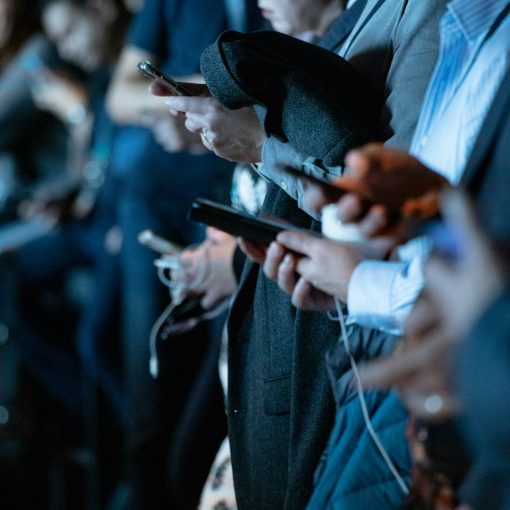 Des hommes semblent obnubilés par leurs téléphones cellulaires.